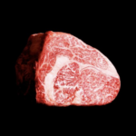 a piece of meat on a black background.