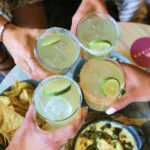 a group of people holding glasses of drinks.