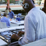 a man with headphones is playing a dj set.