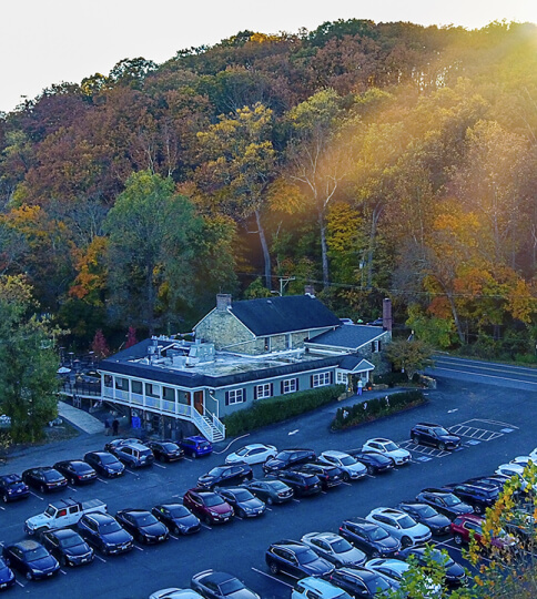 an aerial view of a parking lot with a mountain in the background.